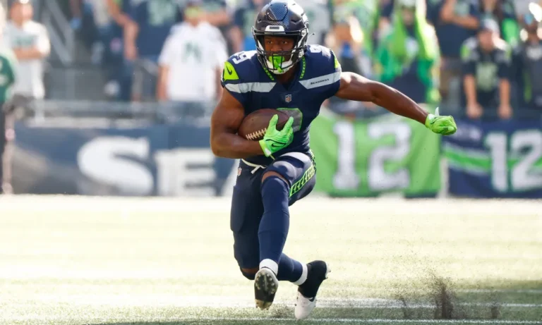 Ken Walker III carries the ball in the 2022 season